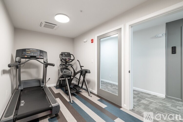 A treadmill and a stationary bike are in a small room.
