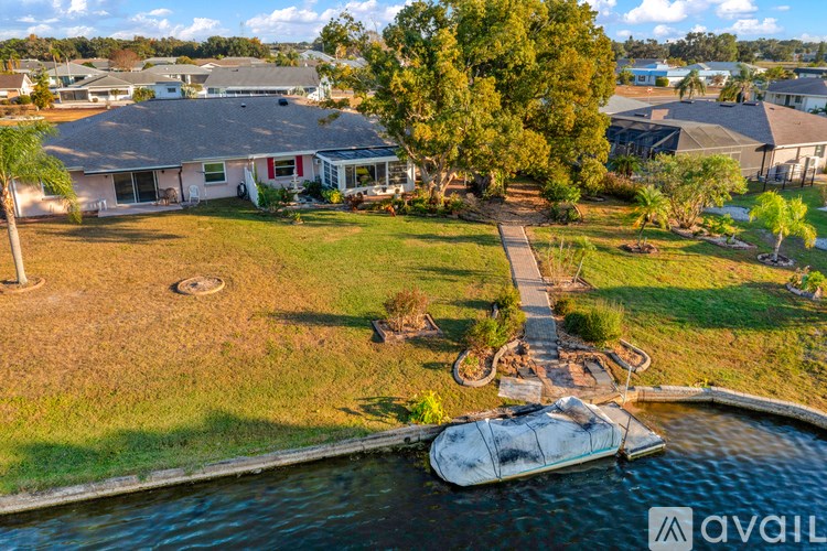 A house with a boat in the front yard.