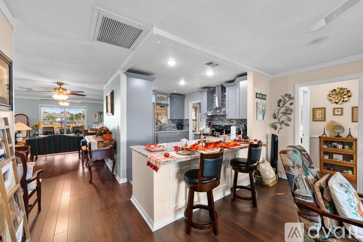 A well-lit kitchen with a dining table set for a meal.
