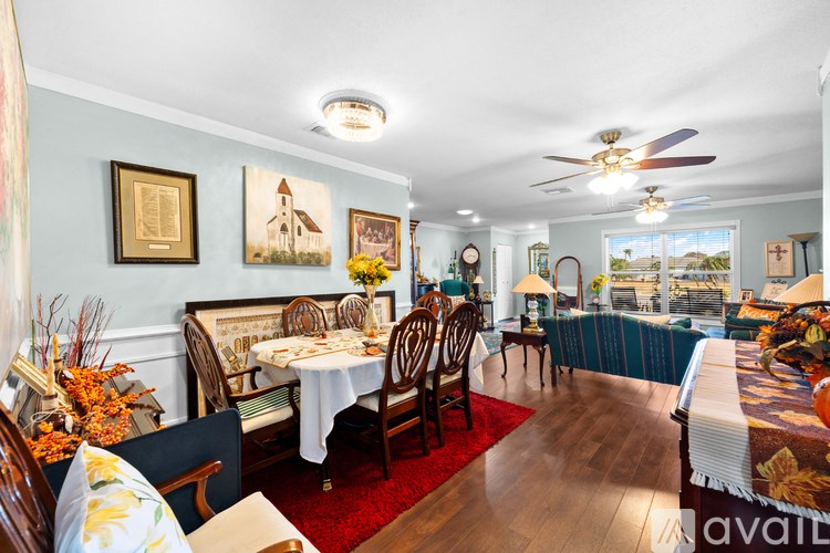 A dining room with a table set for a meal.