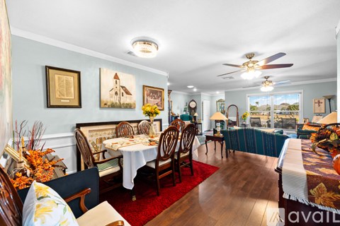 A dining room with a table set for a meal.