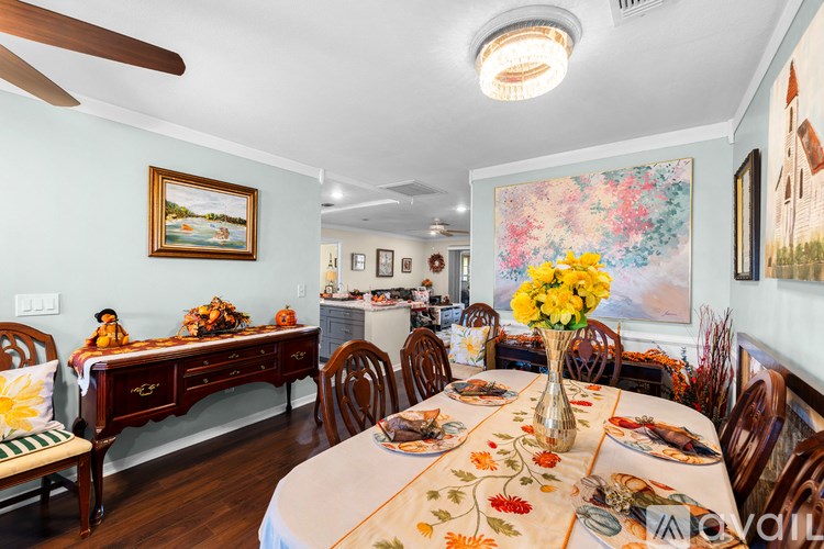 A dining room with a table set for a meal.