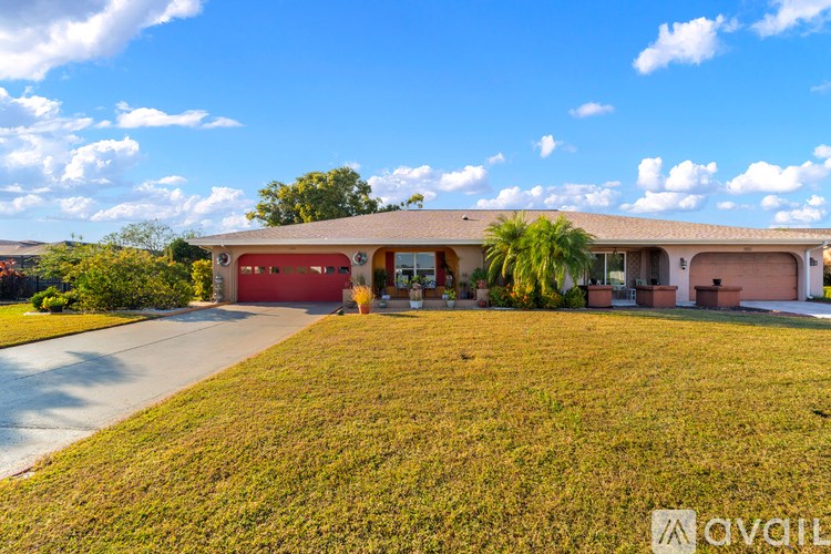 A house with a red garage door is for sale.