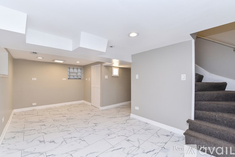 A spacious room with a staircase leading to another level.