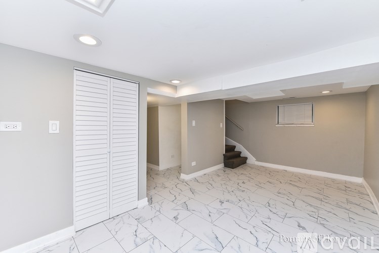 A room with a marble floor and a staircase.