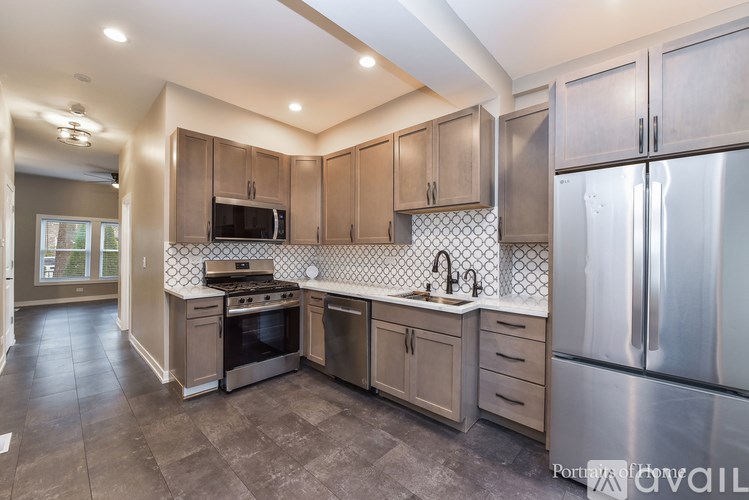 A kitchen with a stove top oven and a refrigerator.