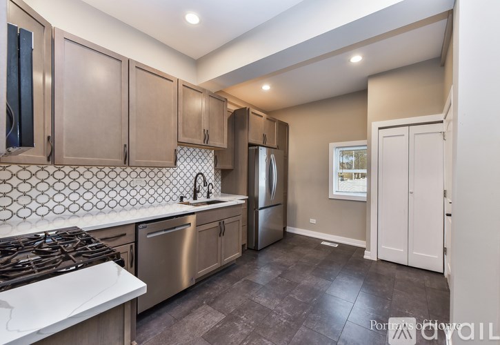A kitchen with a stove top oven and a refrigerator.