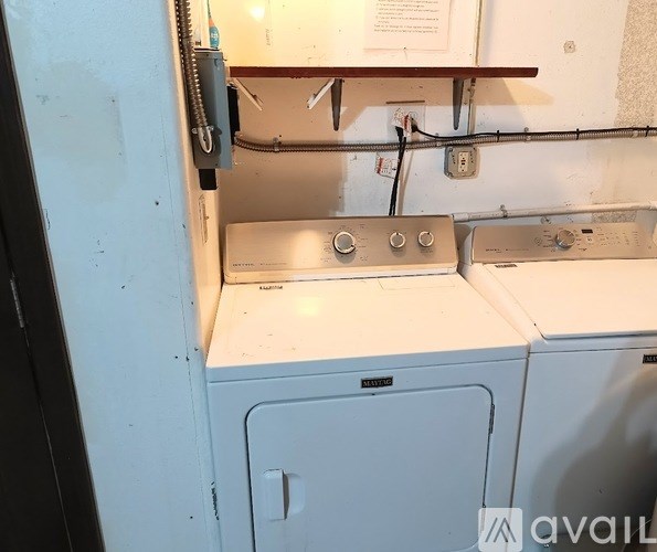 A stack of washing machines in a laundry room.