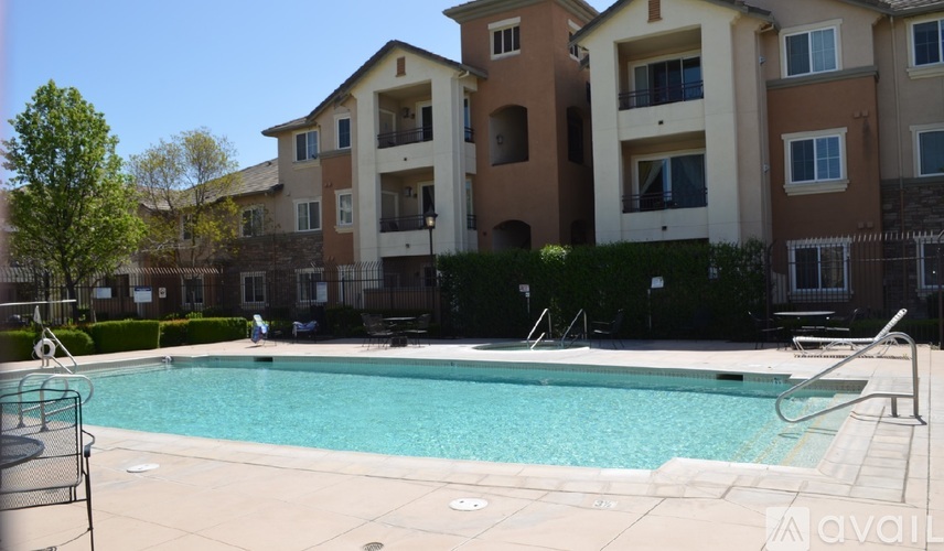 A swimming pool is surrounded by apartment buildings.