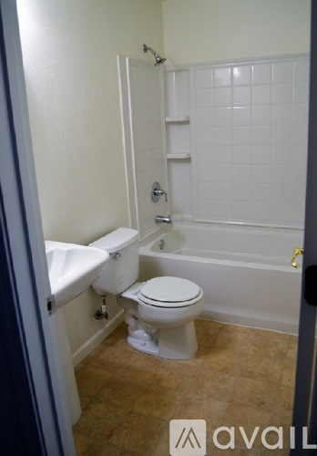 A bathroom with a toilet, sink, and bathtub.