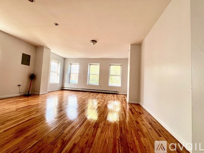A room with wooden floors and white walls.