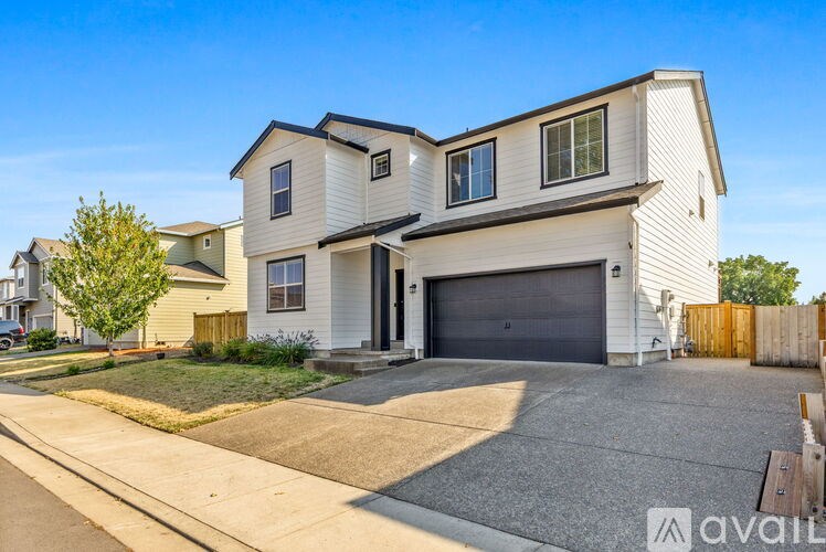 A two-story house with a garage is available for rent.