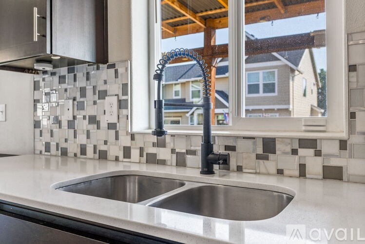 A kitchen with a sink and a window.