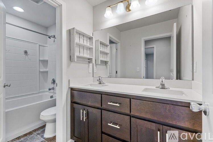 A bathroom with a white toilet and a white bathtub.