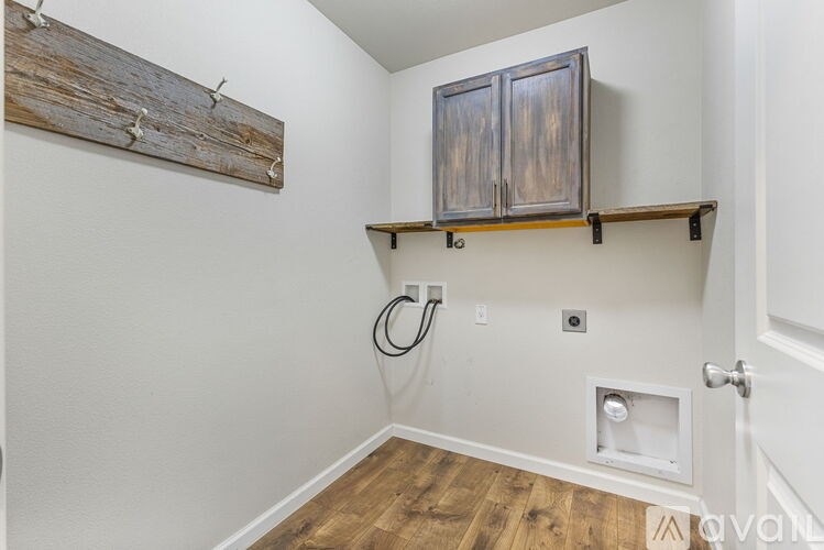 A wooden shelf with a metal cabinet above it and a white door to the right.