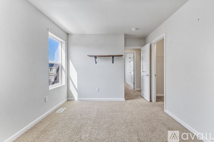 A room with white walls and a carpeted floor.