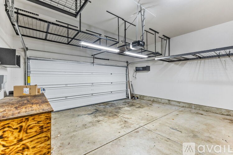 A large, empty garage with a white wall and a white door.
