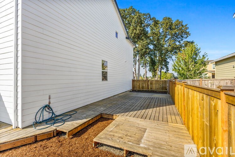 A wooden deck with a hose on it.