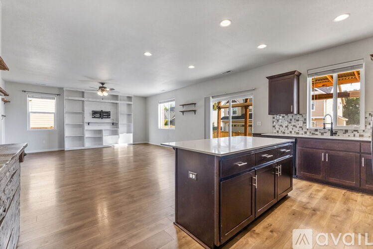 A kitchen with dark wood cabinets and a central island.