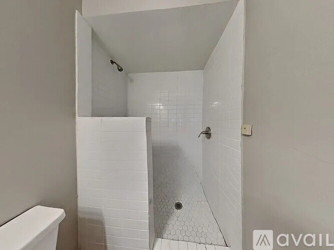 A white bathroom with a walk in shower.