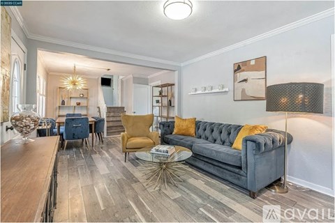 A living room with a grey couch and a wooden table.