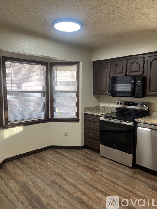 A kitchen with a microwave, oven, and dishwasher.