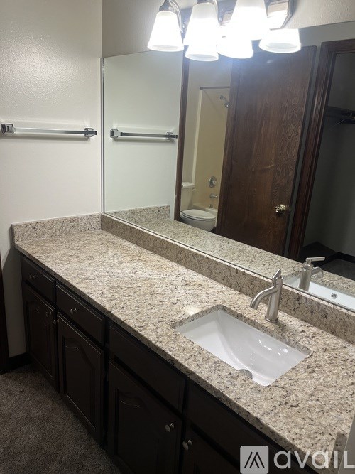 A bathroom with a sink and mirror.