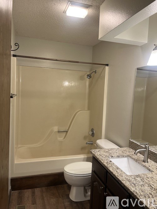 A bathroom with a toilet, sink, and walk-in shower.