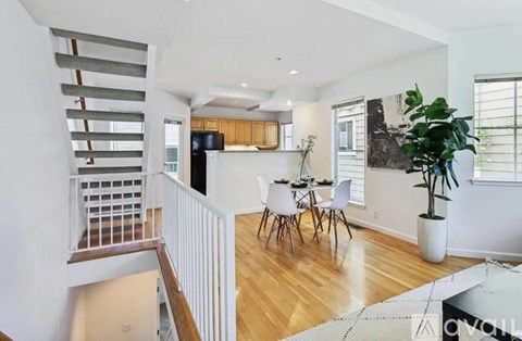 A living room with a dining table and chairs.