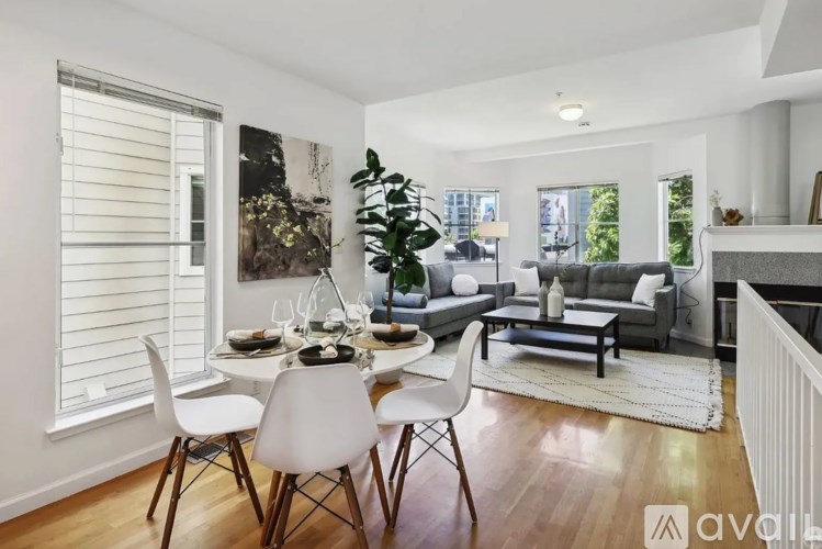 A dining room with a white table and chairs.