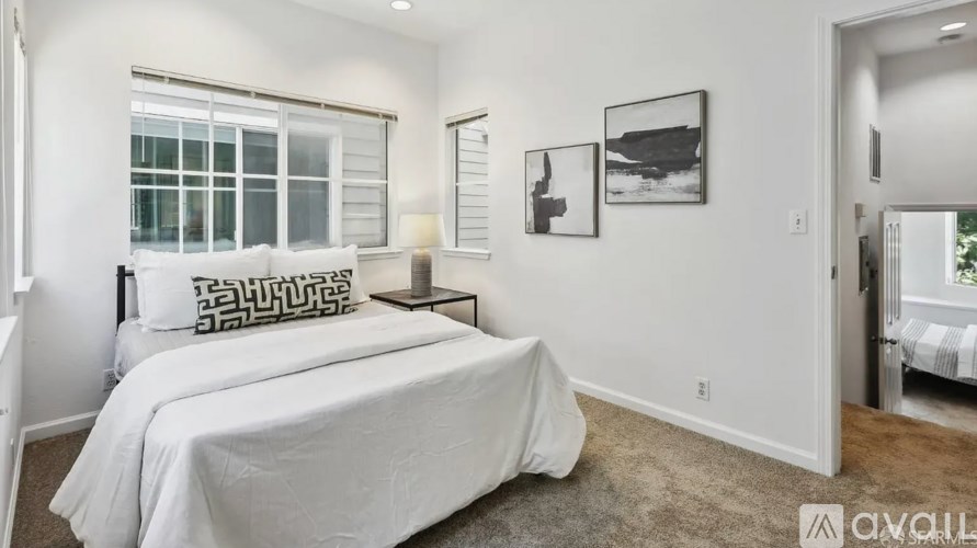 A bedroom with a large bed and a window.