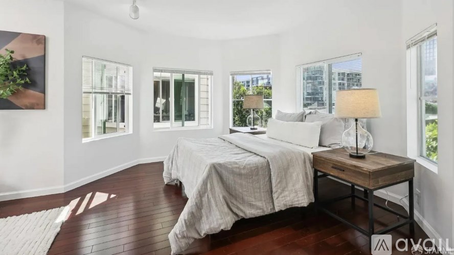 A bedroom with a large bed and a wooden table.
