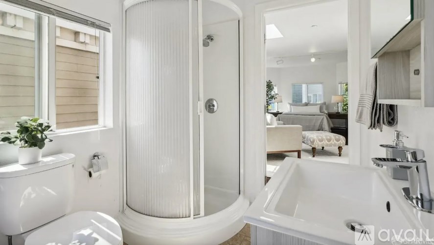 A white bathroom with a large tub and a walk-in shower.