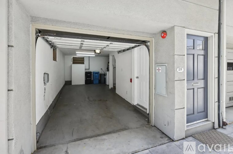 A long hallway with a door on the right and a window on the left.