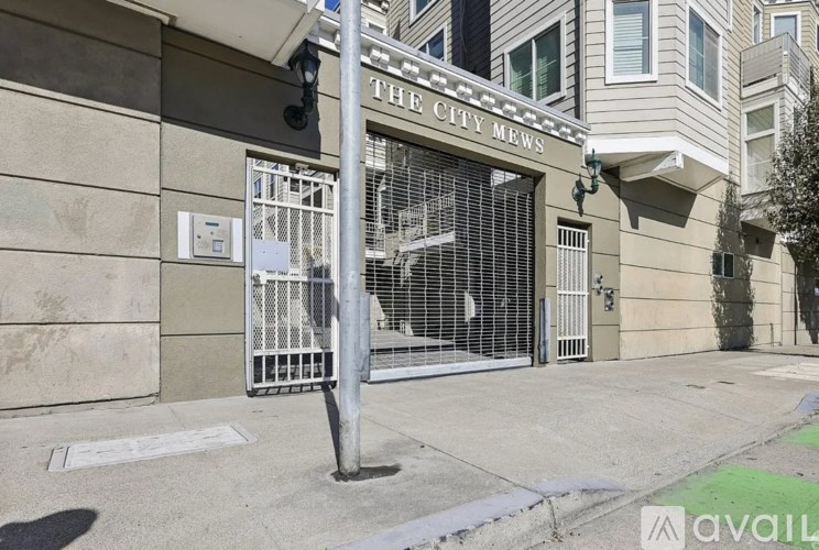 A building with a sign that says "The City Mews".