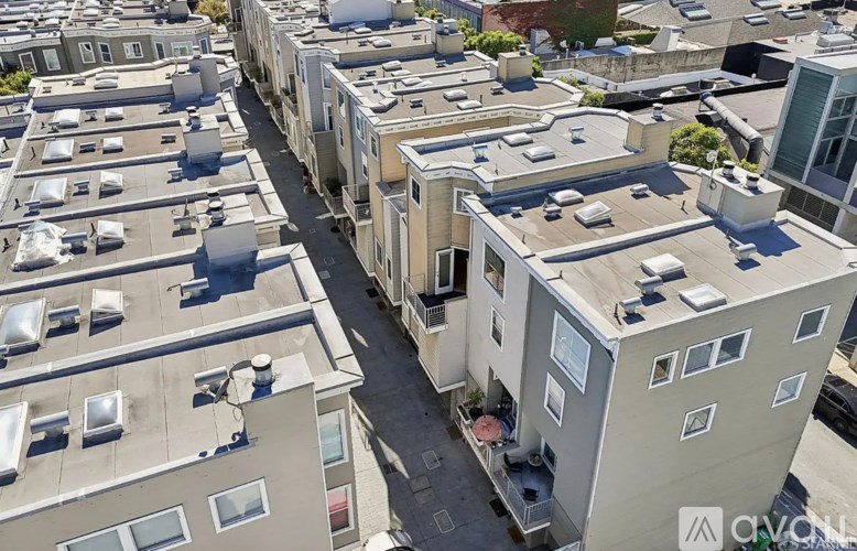 A bird's eye view of a city street with buildings on either side.