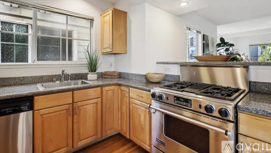 A modern kitchen with wooden cabinets and a stainless steel dishwasher.