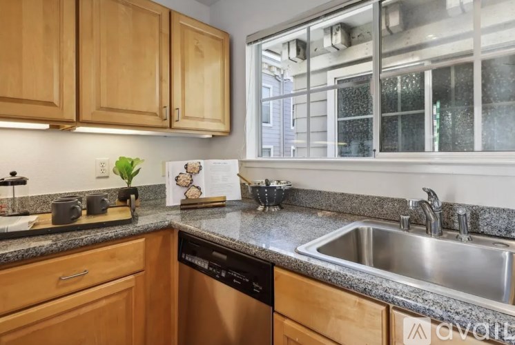 A kitchen with wooden cabinets and a stainless steel sink.