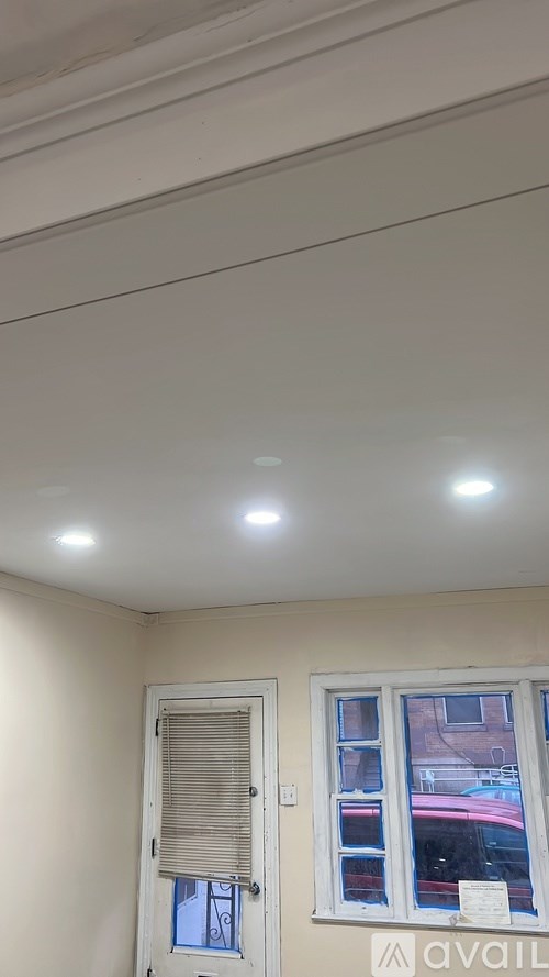 A room with a window and a door.