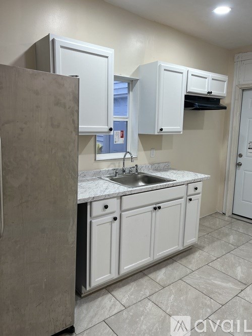 A kitchen with a sink and cabinets.