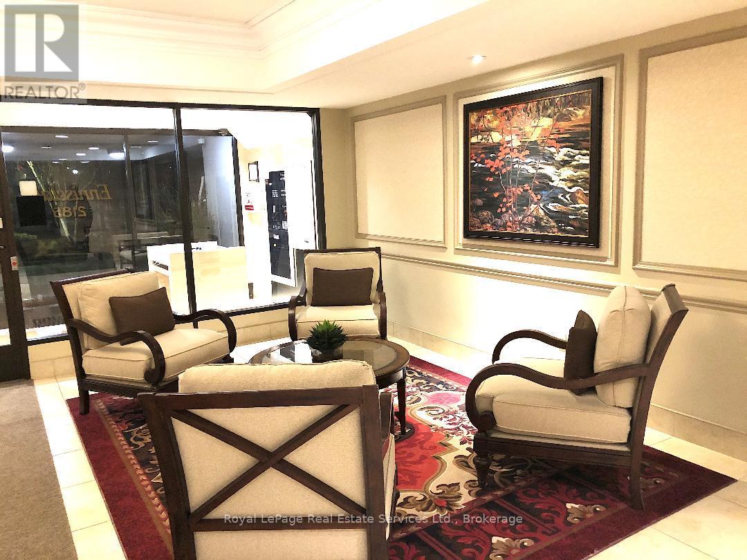 A living room with a rug and two chairs.