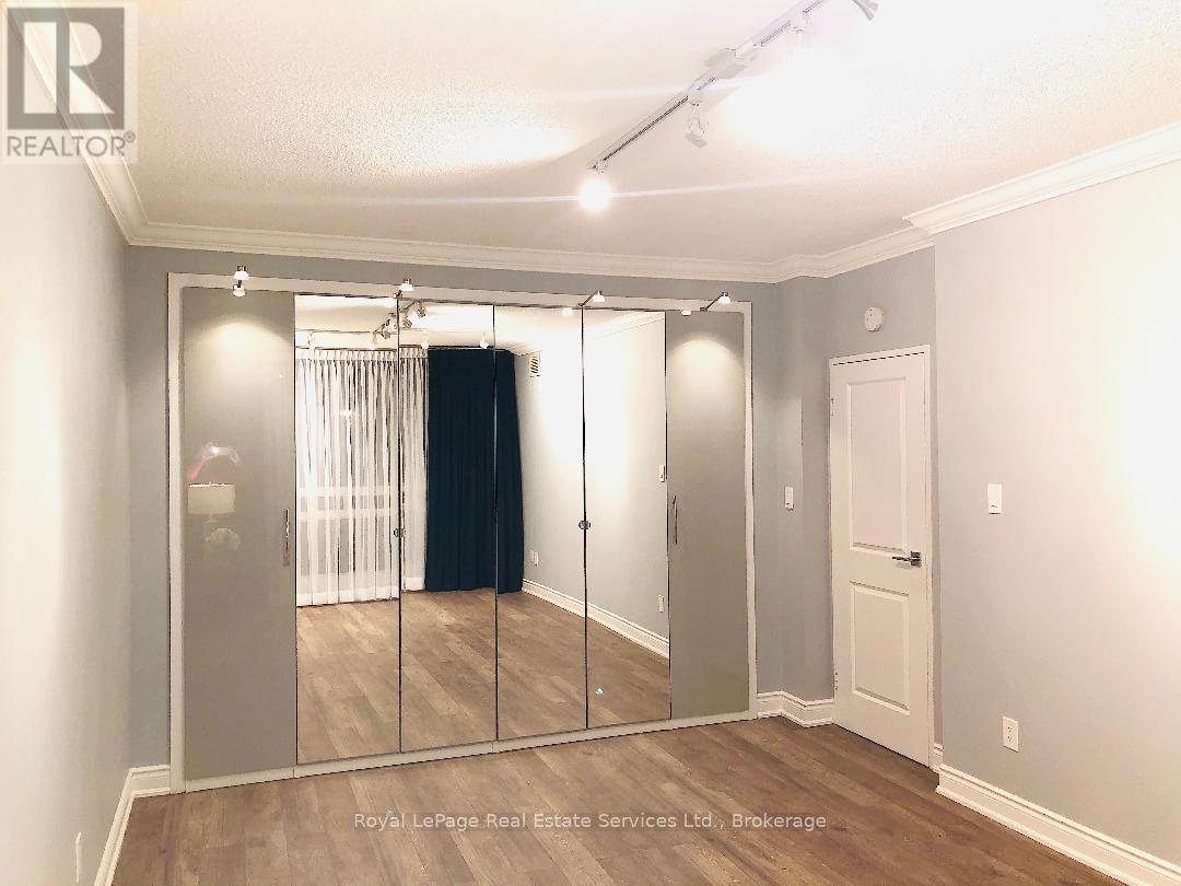 A bedroom with a sliding door and a mirror.