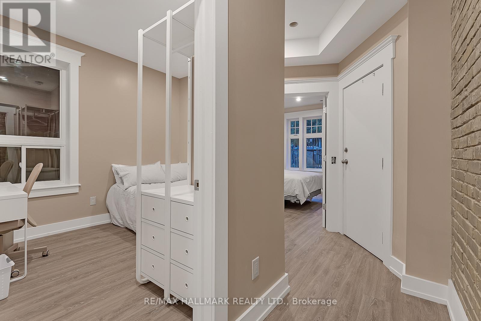 A bedroom with a white bed and a white wardrobe.