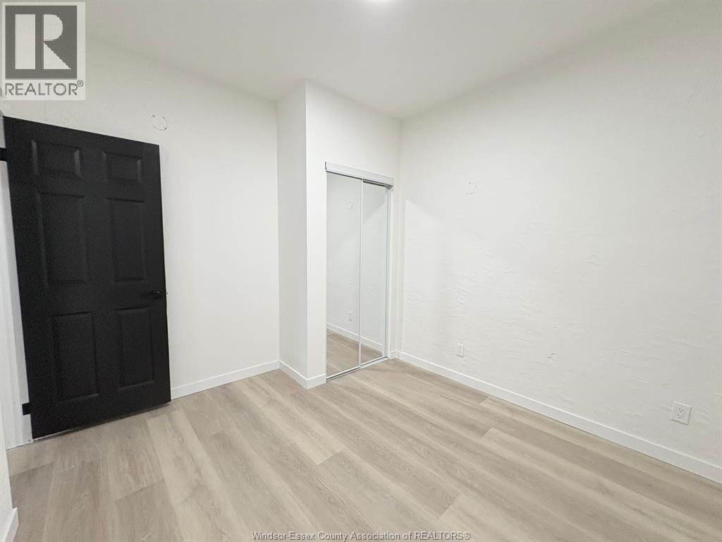A room with a black door and a white door.