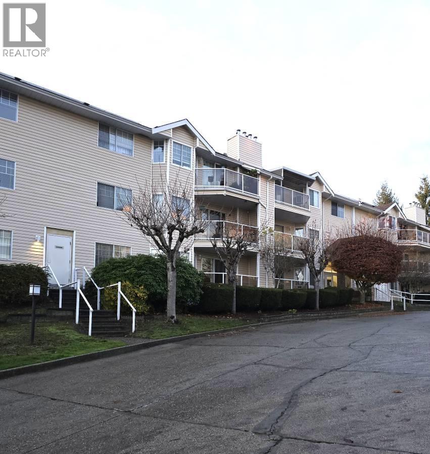 Apartment building with a Realtor sign in front.