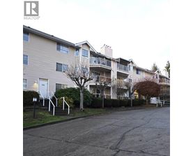 Apartment building with a Realtor sign in front.
