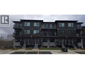 A multi-story building with a parking lot in front.