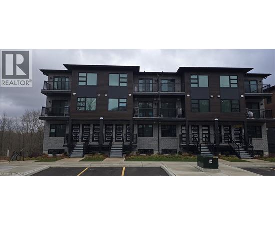 A multi-story building with a parking lot in front.