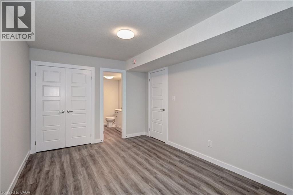 A bedroom with a white door and a grey floor.