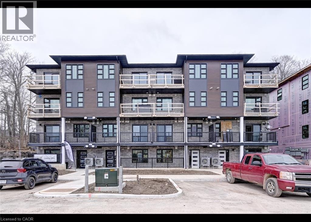 A multi-story building with a parking lot in front.